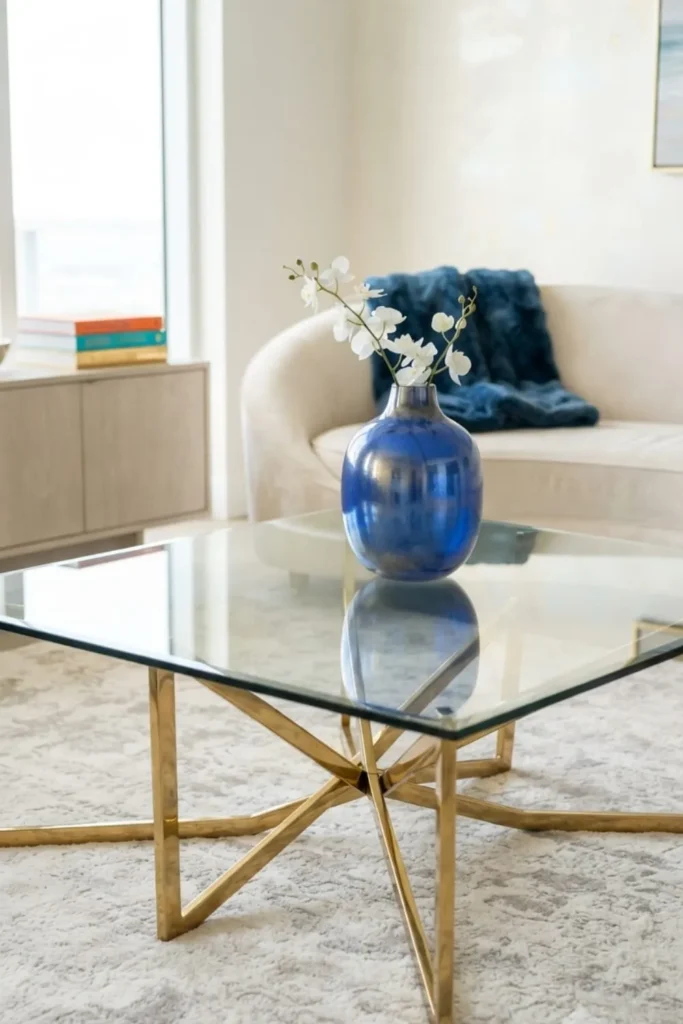 Elegant glass top coffee table style reflecting light in a modern living room.
